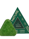 Green triangular shampoo bar with packaging labeled 'Nature Seven Green' on a white background

